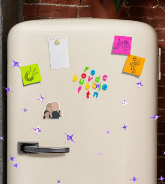 Picture of a fridge that includes a magnet illustration of Taylor Swift and Karlie Kloss