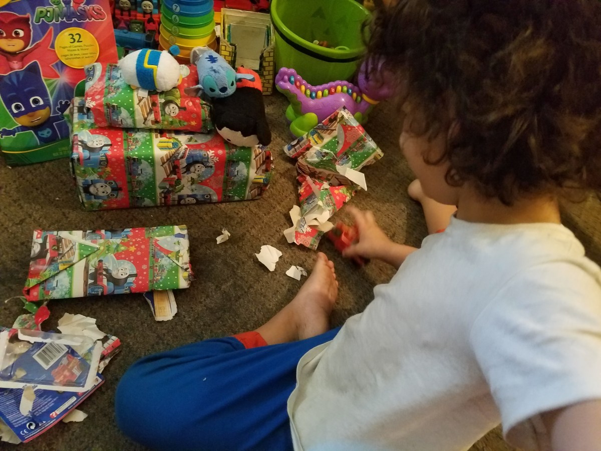 a little kid opening presents