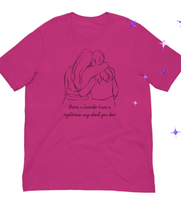 Gaylor gift guide: Magenta shirt with line drawing of two women holding each other and the text "there's a lavender haze, a mysterious way about you dear"