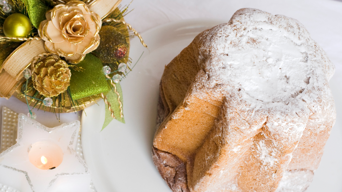 Italian Christmas Desserts: a whole pandoro next to a green and beige centerpiece