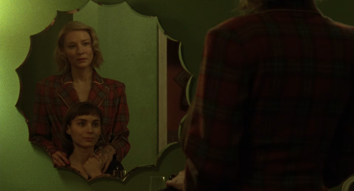 Carol sex scene: Carol stands behind Therese at the mirror