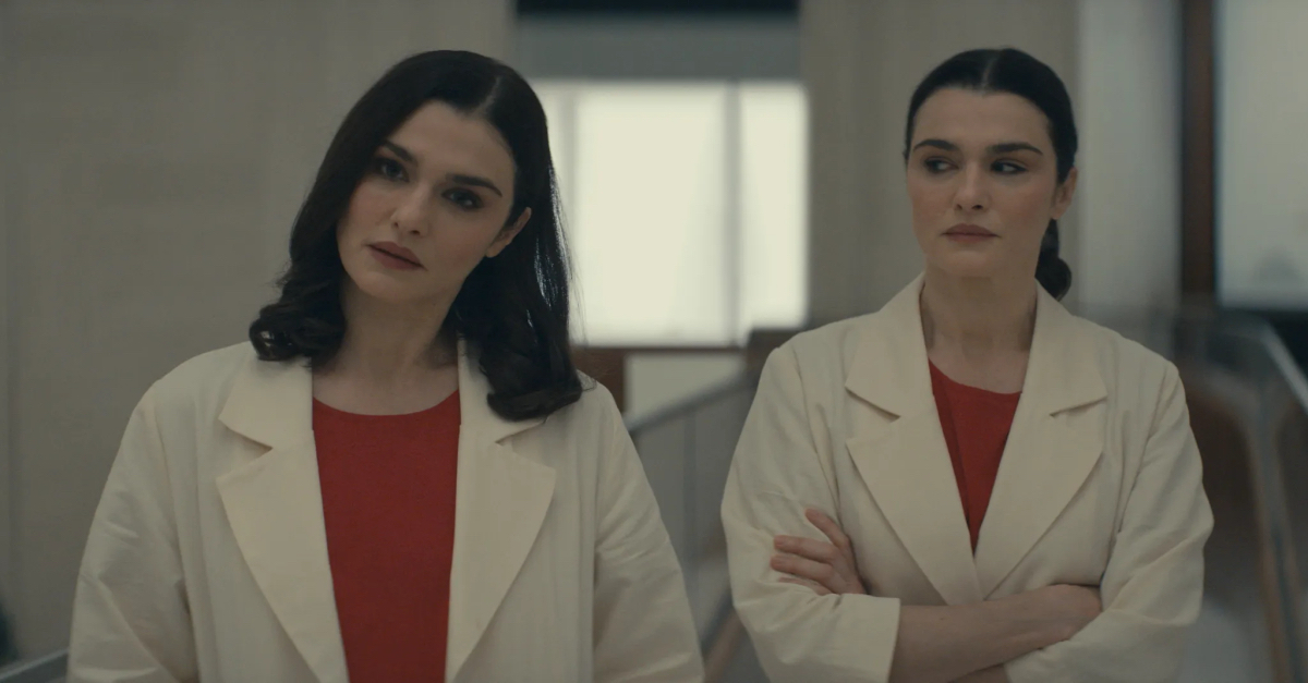 Rachel Weisz in a lab coat as Beverly Mantle looks at Rachel Weisz in a lab coat as Elliot Mantle. Or is it the other way around?