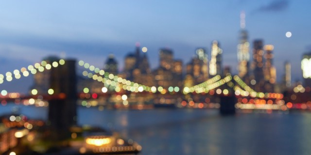 A shimmery out of focus image of the Brooklyn bridge at night