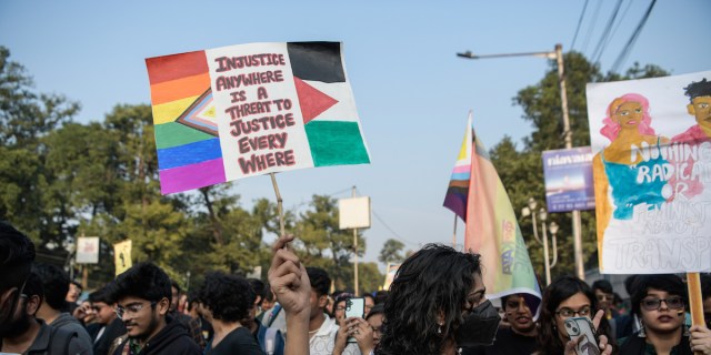 KOLKATA, WEST BENGAL, INDIA - 2023/12/17: A participant holds placards in solidarity with Palestine during the Kolkata Pride Walk. Hundreds of participants took part in Kolkata Pride parade 2023. Kolkata Pride is the longest running pride parade in India. (Photo by Avijit Ghosh/SOPA Images/LightRocket via Getty Images)