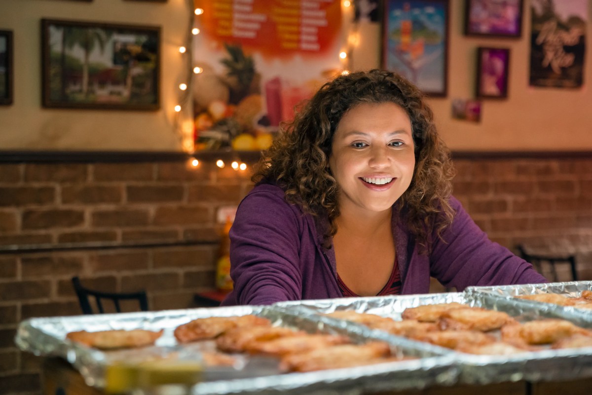 dolores roach looking at some sheets of cookies