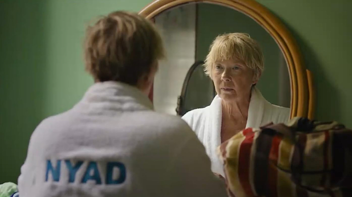 Annette Bening as Diana Nyad stares into a mirror.