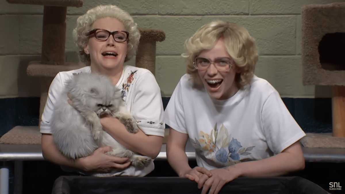 Kate McKinnon and Billie Eilish holding a cat and laughing in the Whiskers R We sketch