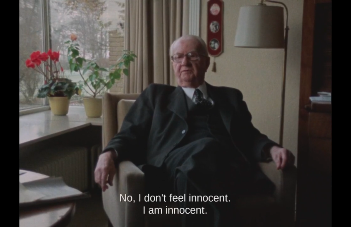 Professor Dr. Gerhard Rose, an old man in a suit, sits back in a chair. CC: No, I don't feel innocent. I am innocent. 