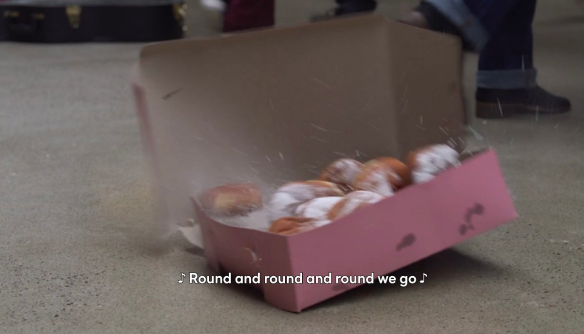 Donuts fallin on the ground with "round and rounda nd round we go"