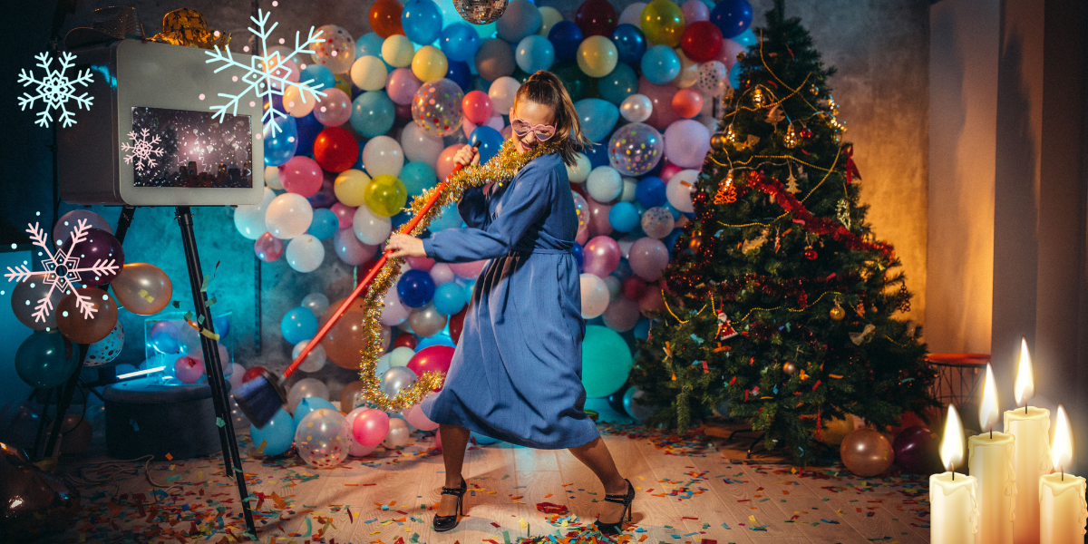 a woman sweeping up a Christmas part in sunglasses next to an easel for some reason