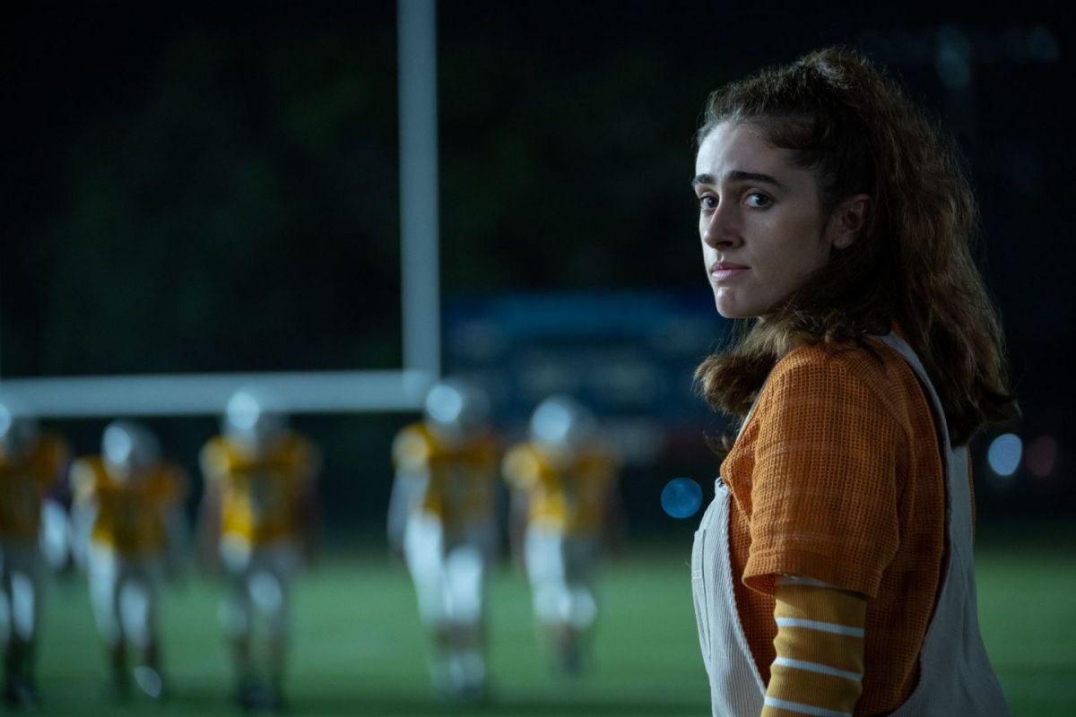 Best Queer Movie Scenes of 2023: Rachel Sennott looks concerned as football players approach from the side.