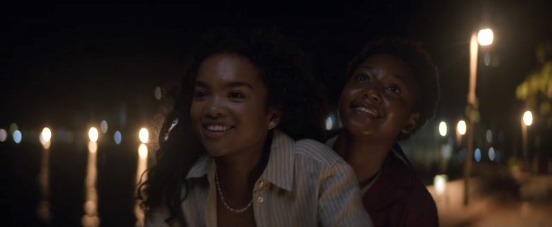 screenshot of covey (left) and bunny (right) riding a motorbike at night in jamaica