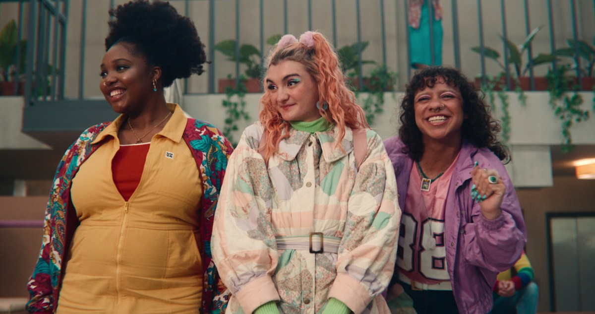 three queer teens wearing loud clothes