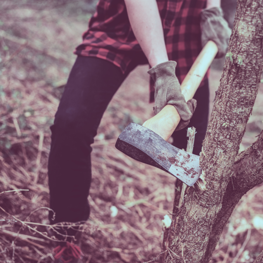 A hand chopping down a tree with an ax