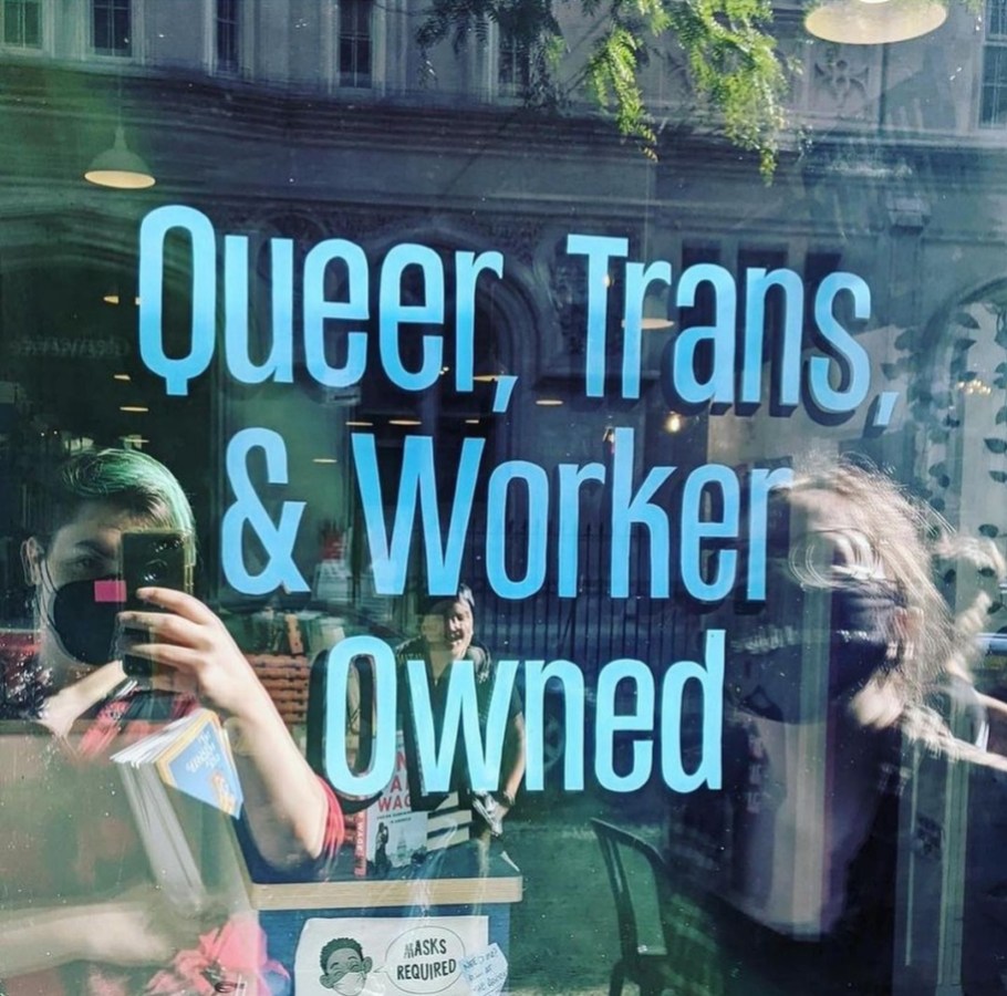 a window at Bluestockings that says QUEER, TRANS, 7 WORKER OWNED