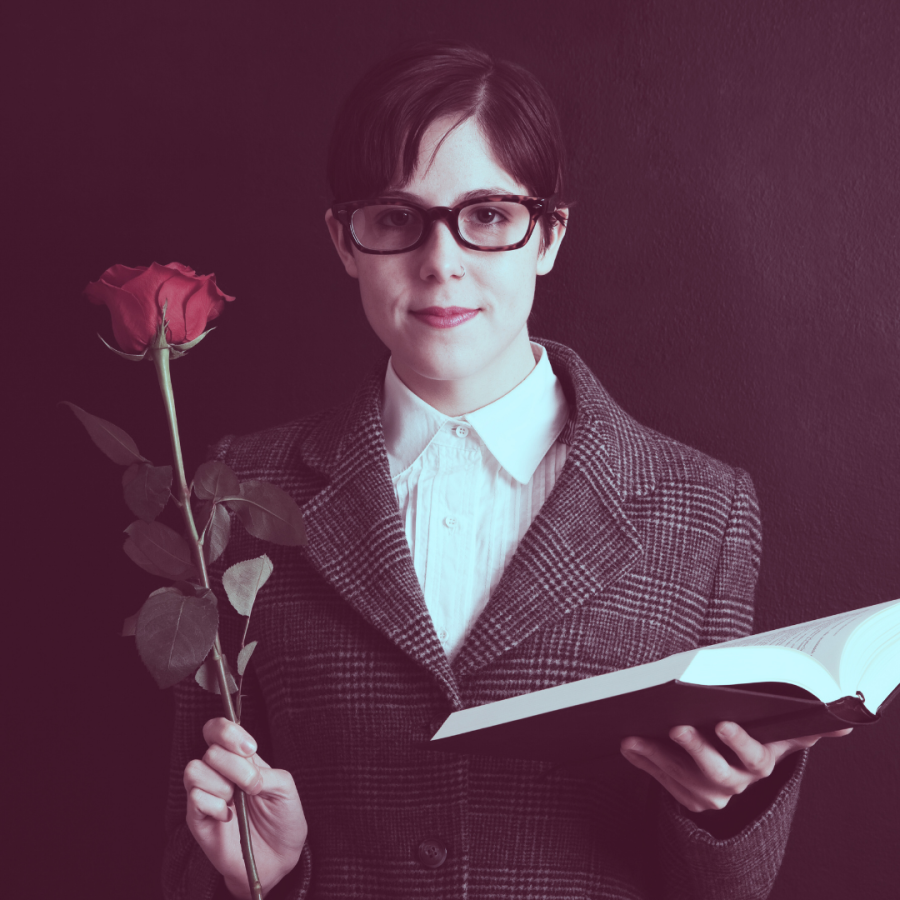 A queer person in glasses with a flower and a book of poetry