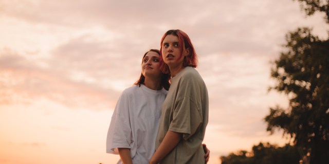 Portrait of young lesbian couple at sunset during summer