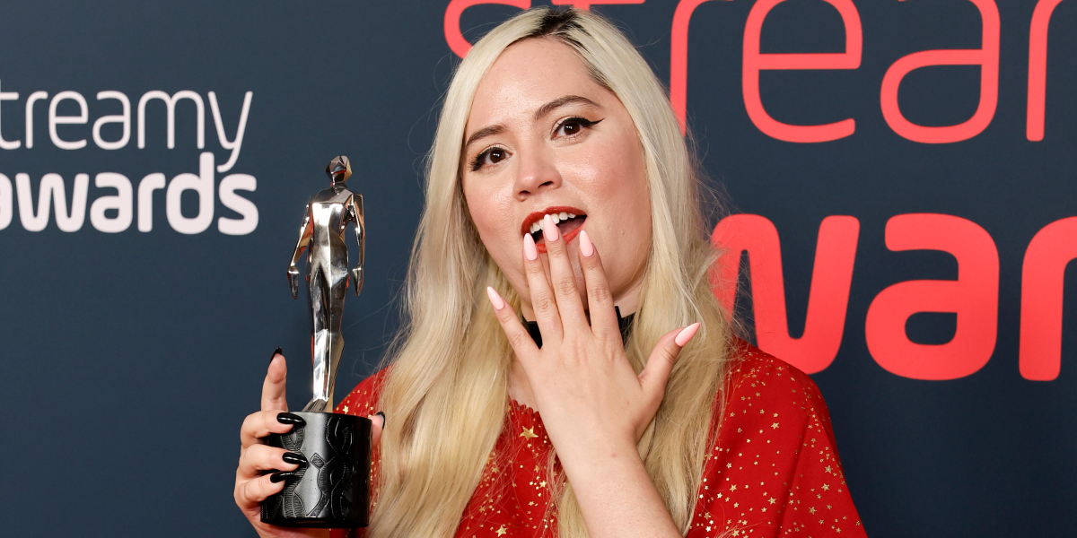 VivziePop interview: VivziePop at the Streamy Awards holding up her award with one hand and putting the other over her mouth in surprise