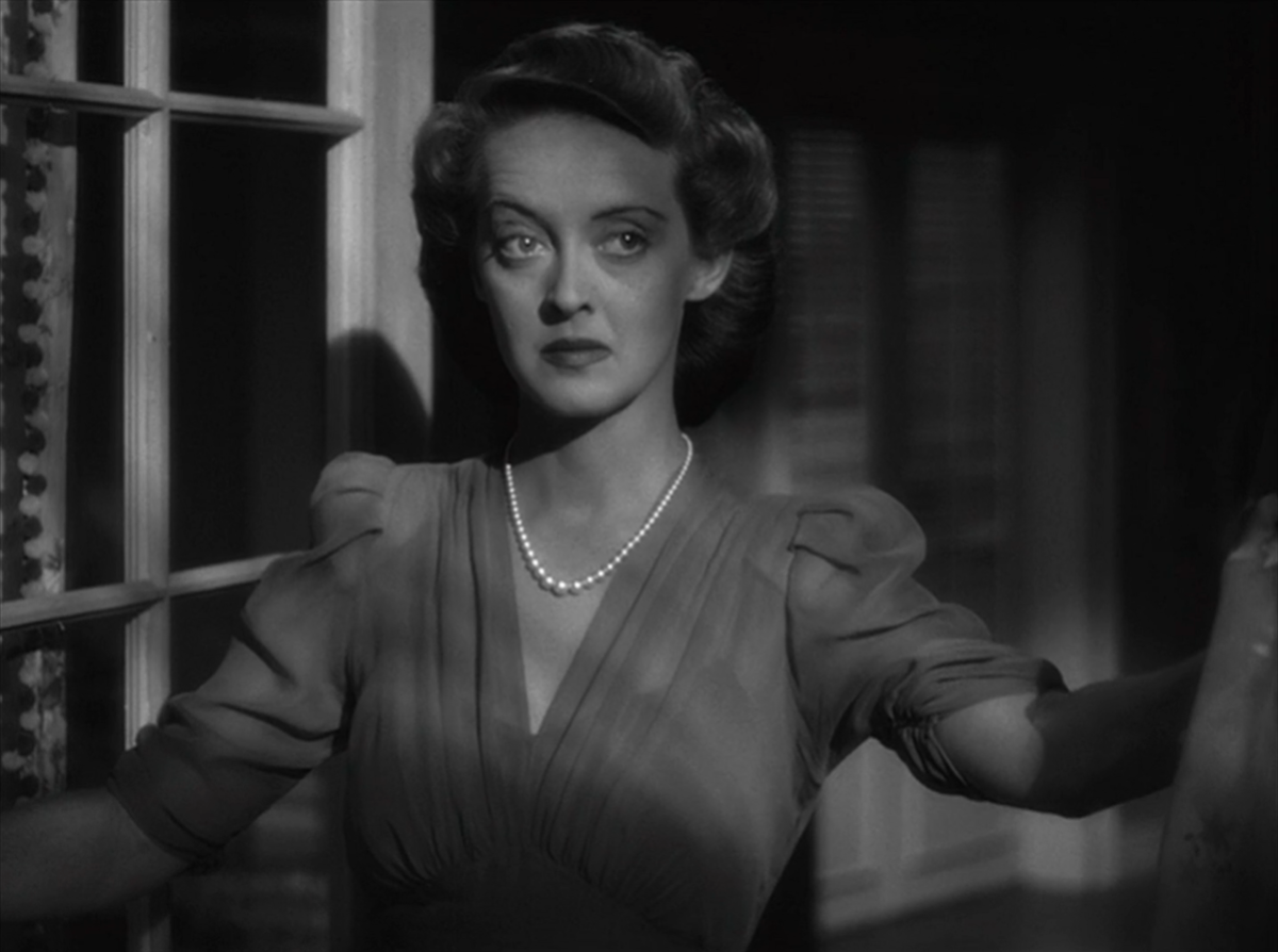 Bette Davis cloaked in shadows.