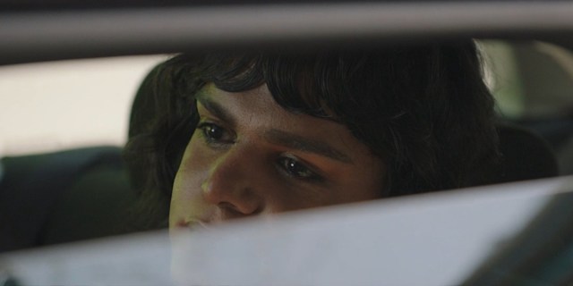 Sort Of season three: Sabi sits in the backseat of a car, half visible through a partially open window.