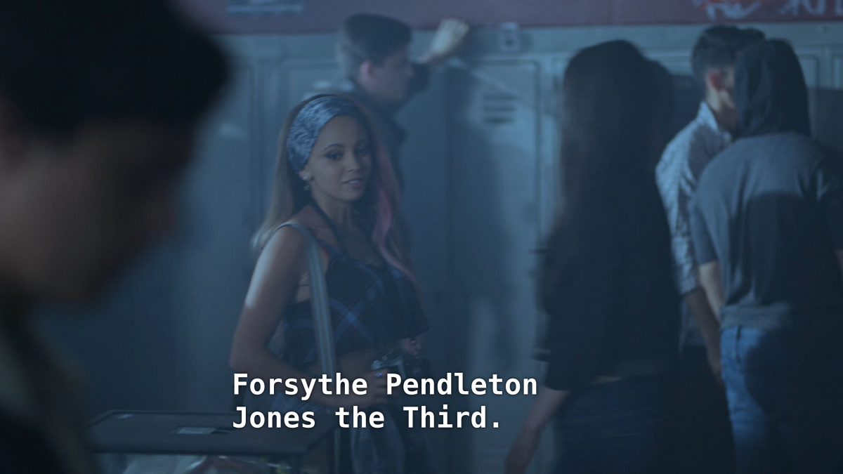 A girl with dyed hair holds a camera and talks to Jughead. "Forsythe Pendleton Jones the Thurd"
