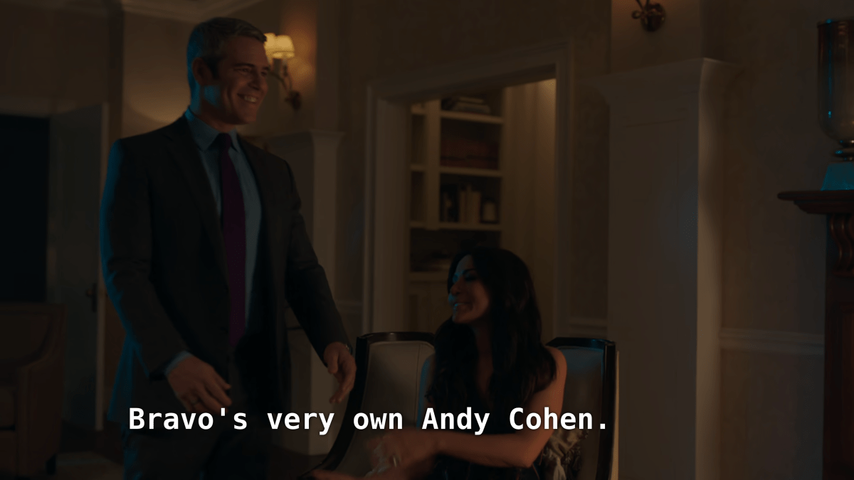 Andy Cohen stands next to Hermione Lodge. "Bravo's very own Andy Cohen."
