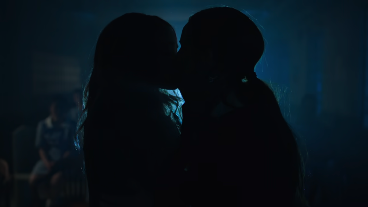 Toni and Cheryl kiss backlit