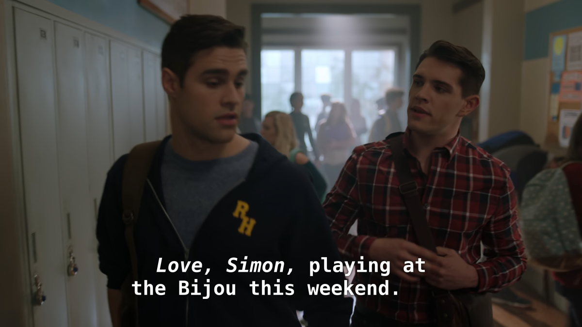 Kevin talks to Moose in the hall. "Love, Simon, playing at the Bijou this weekend."