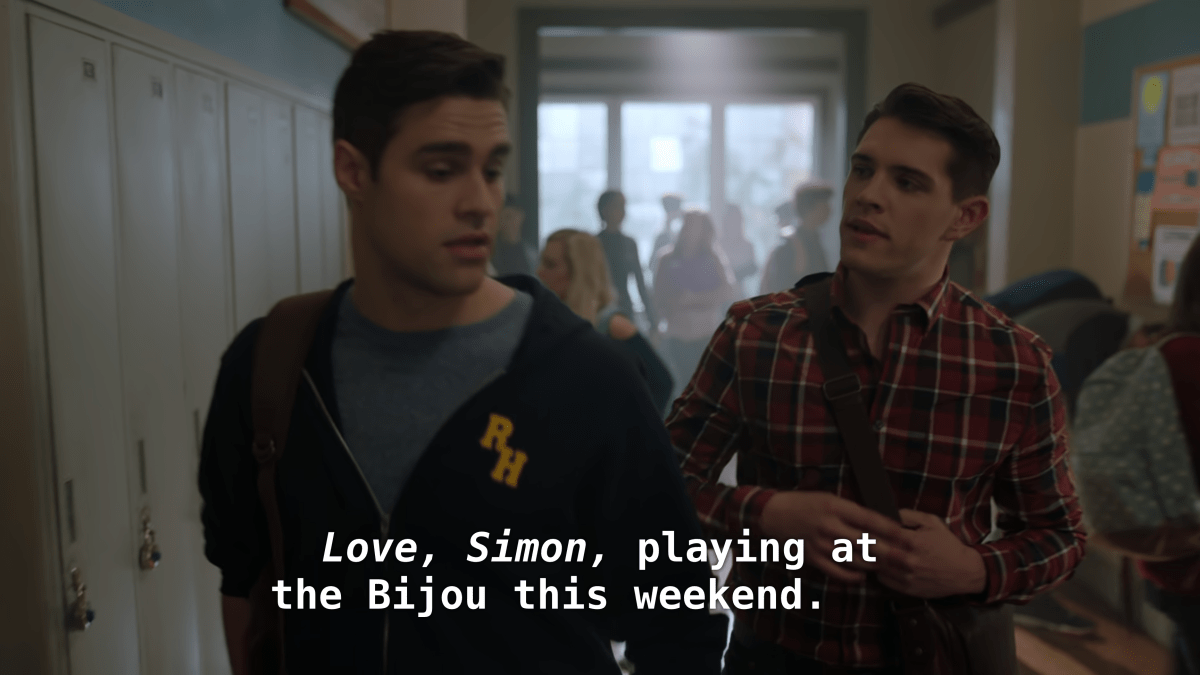 Kevin talks to Moose in the hall. "Love, Simon, playing at the Bijou this weekend."