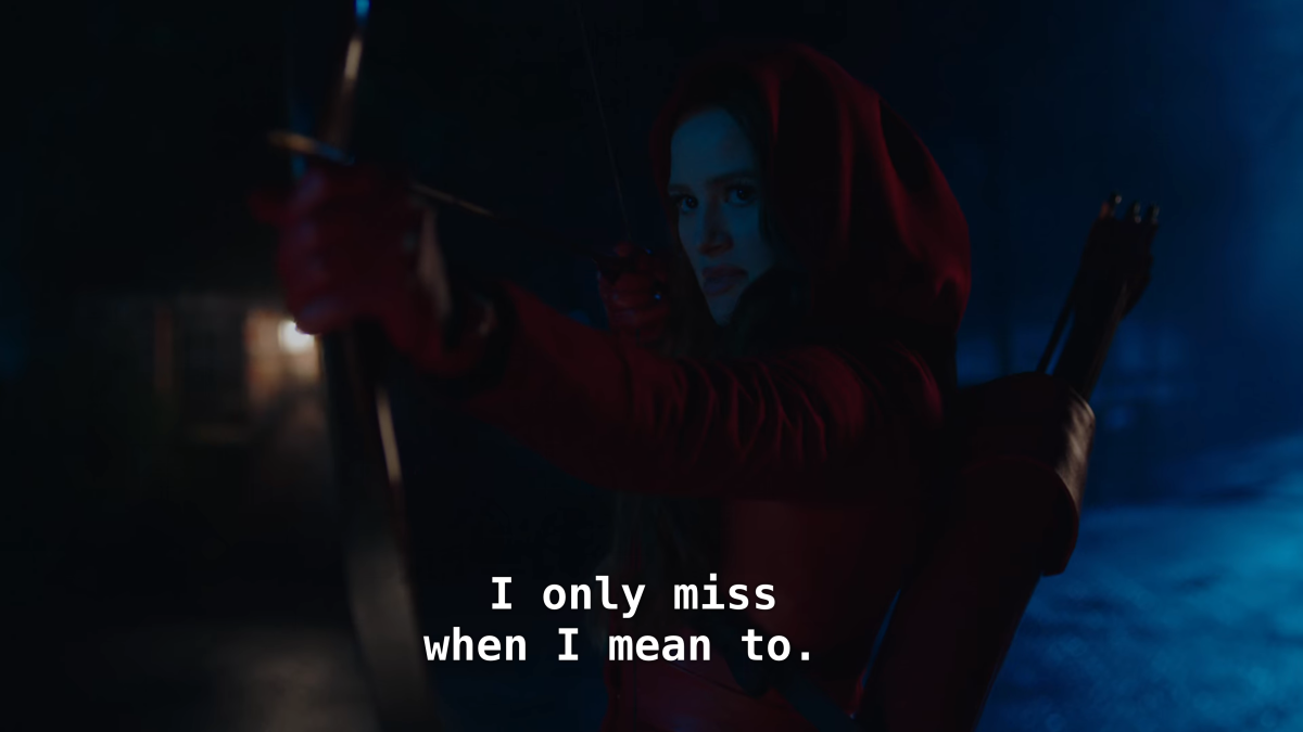 Cheryl in a red hood holds up a bow and arrow. "I only miss when I mean to."