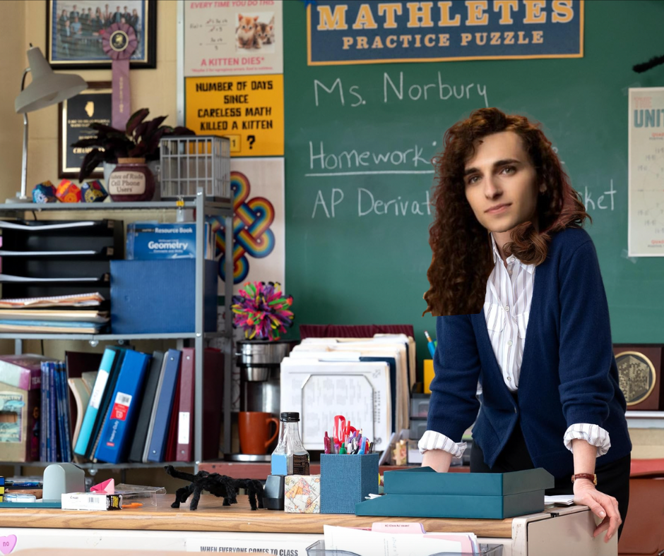 a photo shop hack job where autostraddle senior editor Drew Burnett Gregory's head is photoshopped onto Tina Fey's body in the new Mean Girls. she is in her classroom.