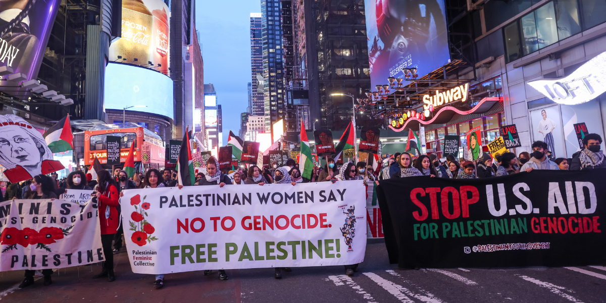 Protesters at a rally outside Kristen Gillibrands home with banners that read PALESTINIAN WOMEN SAY NO TO GENOCIDE FREE PALESTINE and STOP US FUNDING OF GENOCIDE