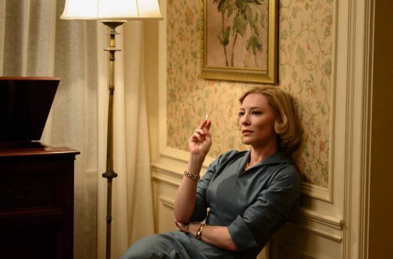 Cate Blanchett smokes a cigarette as Carol in the film Carol