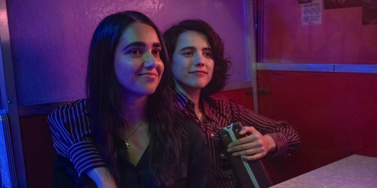 Drive Away Dolls: Margaret Qualley has her arm around Geraldine Viswanathan