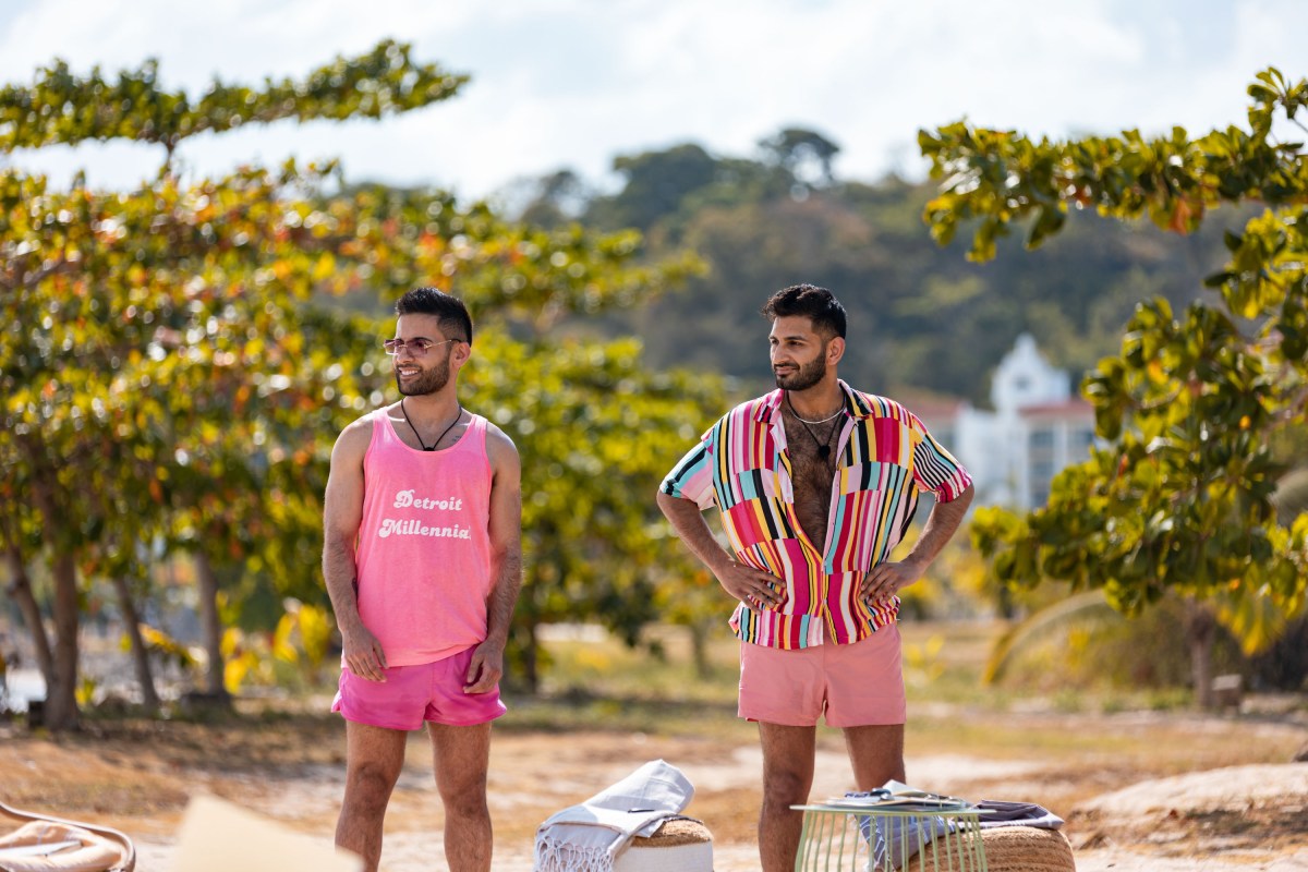 Rehman and Ashmal stand next to each other on the beach