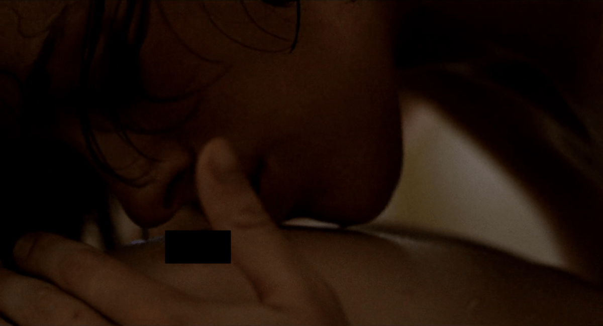 Desert Hearts sex scene: Cay kisses Vivian's breast (a black square is over her nipple)