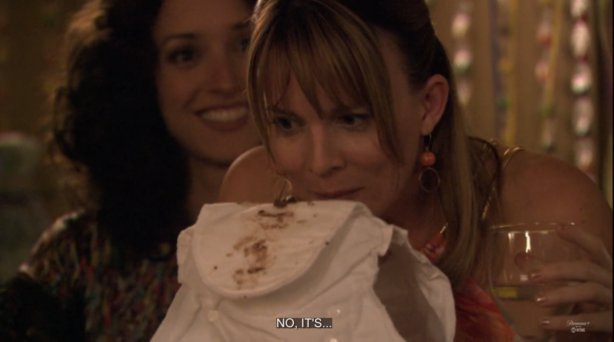 Tina sniffing a diaper with chocolate in it