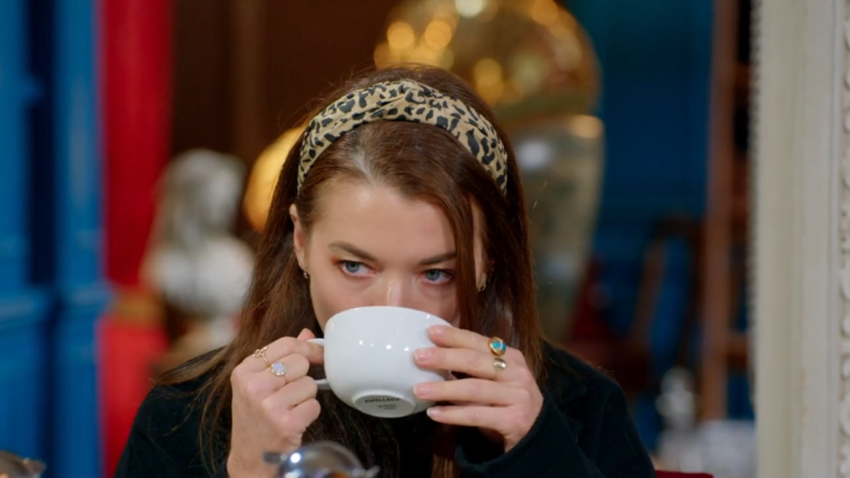 Pavarti sips tea in a leopard headband