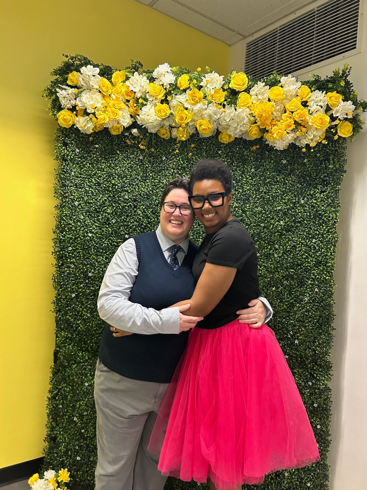 The author (a black woman with short hair) and her wife (a white butch with brown hair) pose on their wedding day.