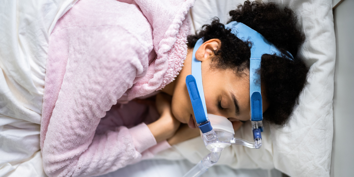 a woman sleeps in a CPAP machine