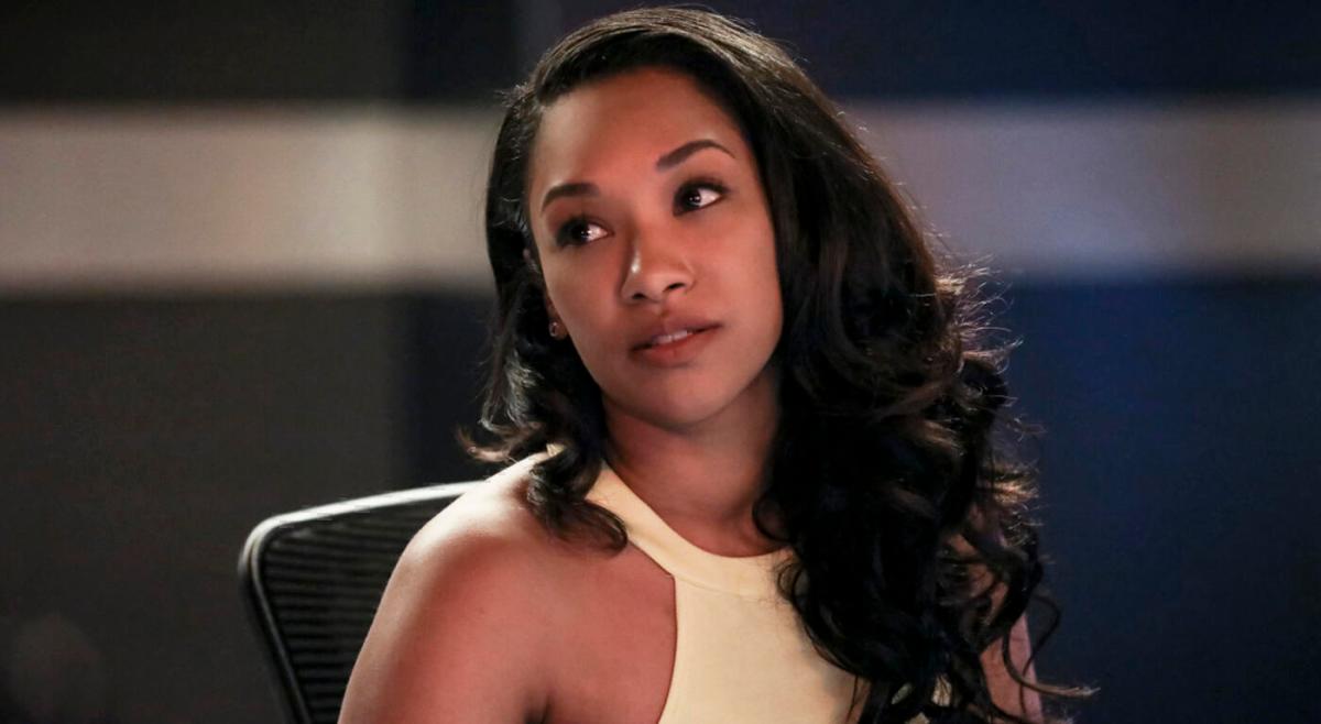 Candice Patton as Iris West in The Flash looks up while sitting at a table