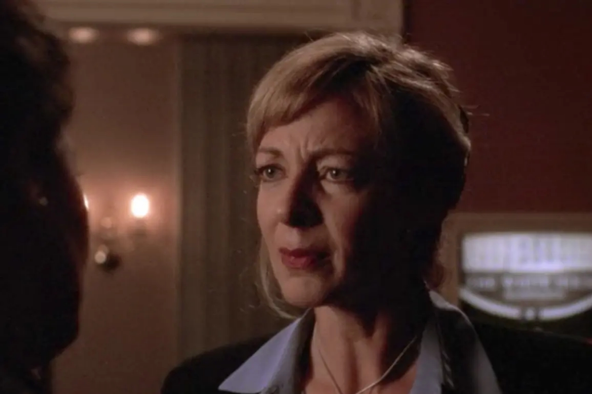 Allison Janey as C.J Cregg looks at someone with a serious expression.