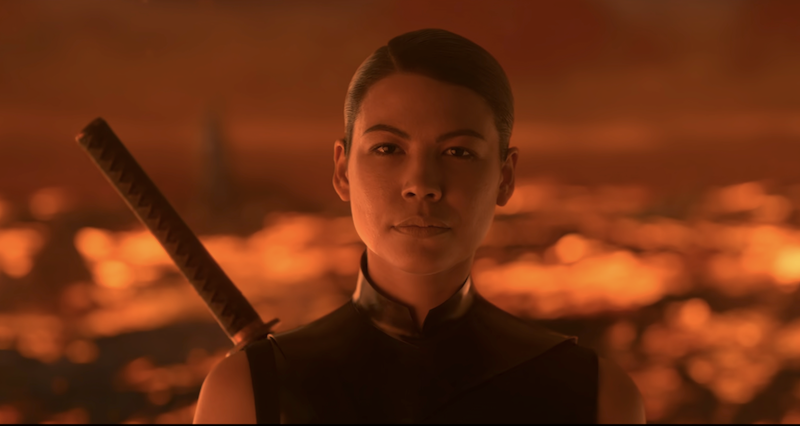 Screenshot of Sea Shimooka as Sophon from 3 Body Problem. She stands against a fiery backdrop while dressed in black leather and a katana strapped to her back.
