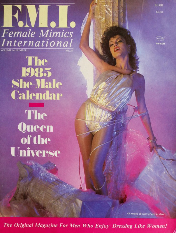 F.M.I. Female Mimics International Magazine Cover, The 19855 She-Male Calendar The Queen of the Universe, a trans woman in shimmery white leans back against a Greek column. 