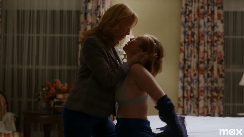 Hacks trailer: Christina Hendricks and Hannah Einbinder kiss on a bed; Christina's character is coming in to kiss Ava, who is taking off her shirt 