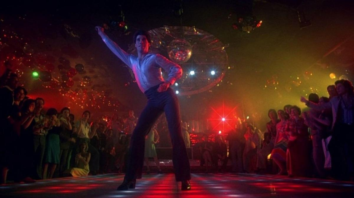 John Travolta dances in dark lighting in Saturday Night Fever