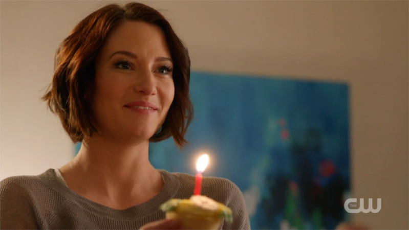 Supergirl: Alex holds a cupcake with a candle on it