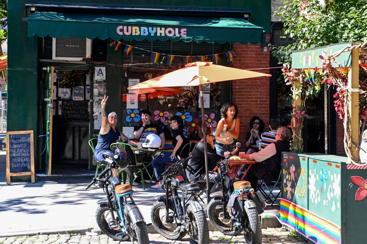 NEW YORK, NEW YORK - JUNE 17: Customers pose and make hand gestures outside Cubbyhole, a well known lesbian & gay bar, in the West Village on June 17, 2021 in New York City. On May 19, 2021 New York Governor Andrew Cuomo lifted all coronavirus pandemic restrictions paving the way for most Pride month events to resume normally. New York City Pride weekend will be June 25th-27th. 
