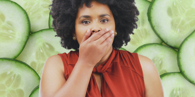 A woman gasping with cucumbers behind her