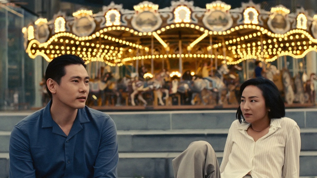 past lives still, two people by a carousel looking wistful